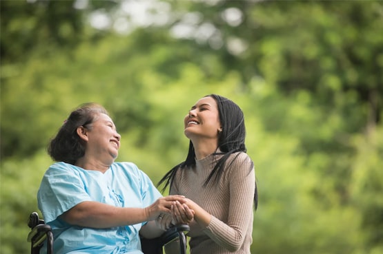 caregiver caring for an elderly loved on at home
