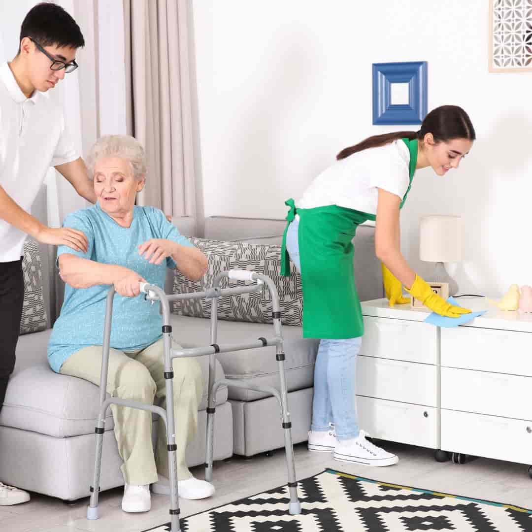 Caregiver doing light housekeeping service for senior at home